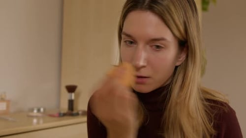 Woman Applying Makeup Foundation and Concealer Close Up