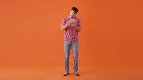 Male Holding Pen and Making Notes in Diary in Studio