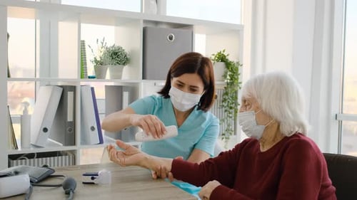 Medical Worker Examines Senior Patient in Office