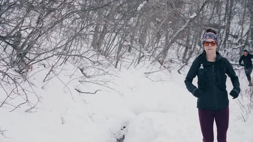 Active Couple Trail Running in Winter Action