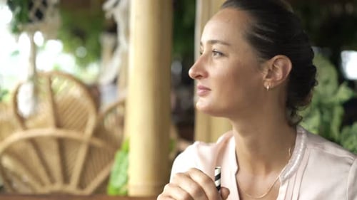 Woman Drinking Cocktail Sitting In Cafe
