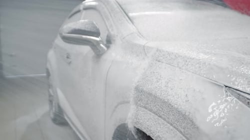 Highpressure Foam is Applied to Automobile for Touchless Washing Side View At Car Wash They Wash Car