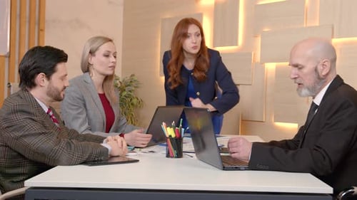 Serious Business Team Meeting in Modern Office