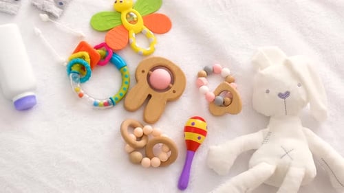 Baby Toys and Accessories on the Bed Selective Focus