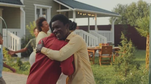 Family Gathering in Suburban Yard with Hugs and Smiles