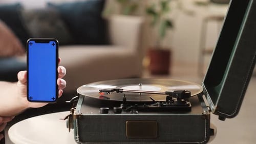 Vinyl Record with Phone and Blue Chroma Key Closeup
