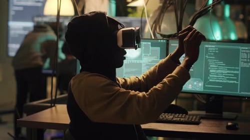 Young Adult Using VR Headset in Dark Office
