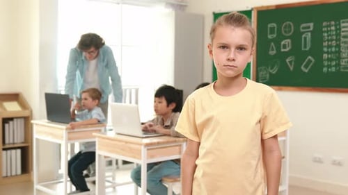 Caucasian student looking at camera while friend studying about code. Pedagogy.
