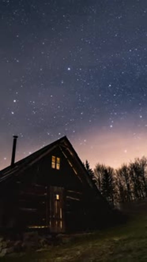 Starry Night Sky over Wooden Cabin in Forest