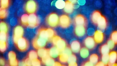 Blurred light spots seamless loop circle color bokeh lights background. defocused lens light
