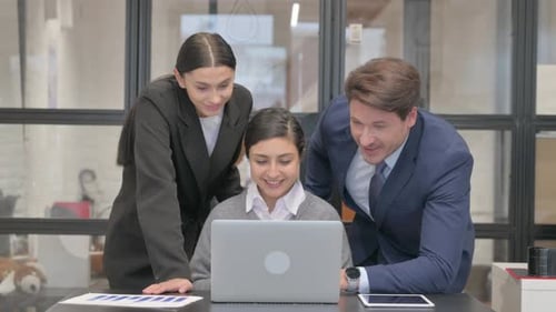 Team Collaborating on Video Call in Modern Office