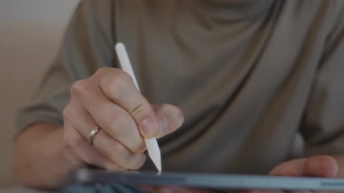 Man Using Digital Tablet with Stylus Pen Close Up