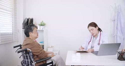 Doctor Consults Senior Patient in Bright Office