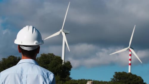 Engineer Taking A Look At The Wind Turbines