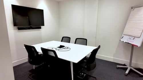 Modern Meeting Room Interior With White Table Black Chairs Tv Screen And Flip Chart For Corporate