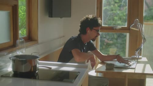 Man Working From Home on Laptop During Daytime