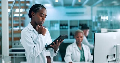 Woman Working on Tablet in a Bright Laboratory