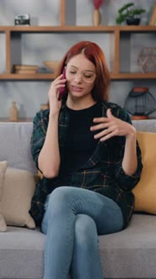 Woman Talking on Cell Phone Sitting on Couch