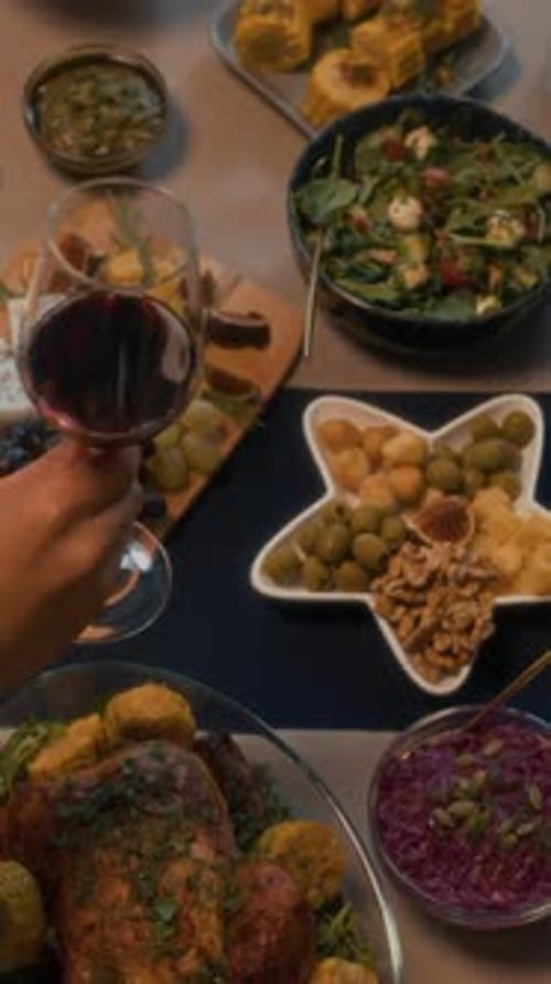 Friends Sharing Meal and Raising Wine Glasses