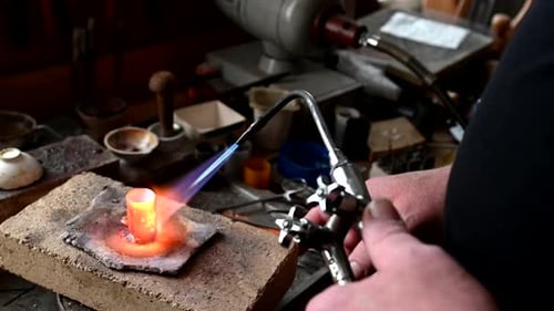 Gold Wedding Ring Making By Goldsmith Isolated Jeweler Melts Gold in Liquid State in Crucible Macro