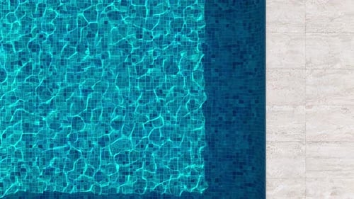 Swimming Pool Top-Down View with Blue Water and Beige Stone Tile Deck