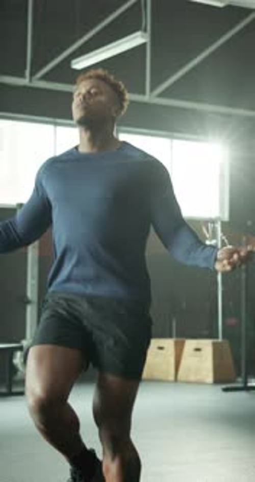 Man, workout and skipping in gym for fitness, improve coordination or cardio exercise