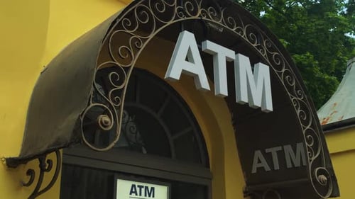 ATM Entrance Featuring a Beautifully Designed Decorative Overhang Set Against a Bright Yellow