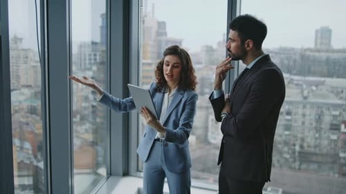 Professionals Discussing a Project in Modern Office