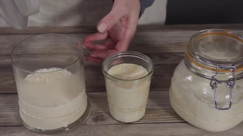 Sourdough Starter in Glass Jars on Wood Table