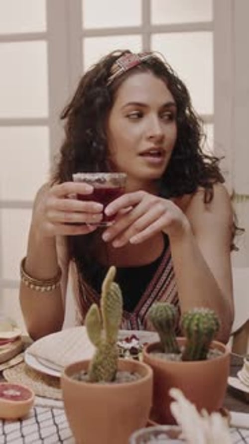 Woman with Curly Hair at Table Talking