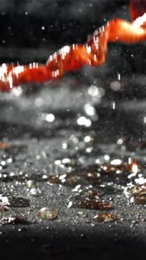 The Bacon is Fried in a Pan with a Splash of Oil Filmed on a Highspeed Camera at 1000 Fps