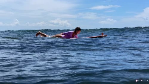 Caucasian Woman Playful Surfer Kicking And Splashing On Board
