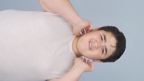 Vertical Video of Boy with itchy ears.