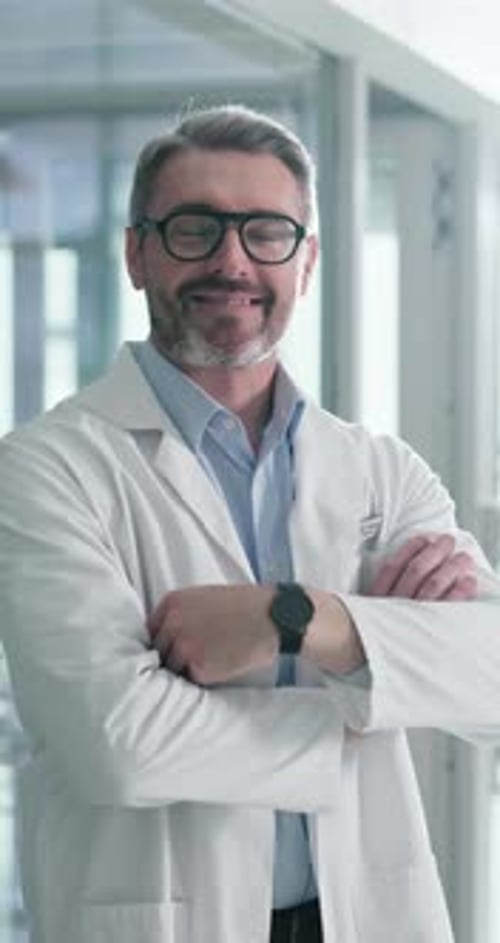 Smiling Man Wearing Lab Coat with Arms Crossed