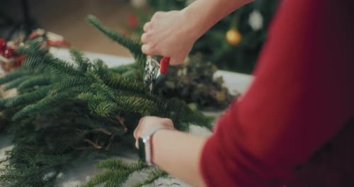 Woman Preparing Christmas Wreath Garland For Christmas Holidays