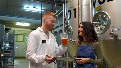 Brewmaster Tasting and Analyzing Freshly Brewed Beer