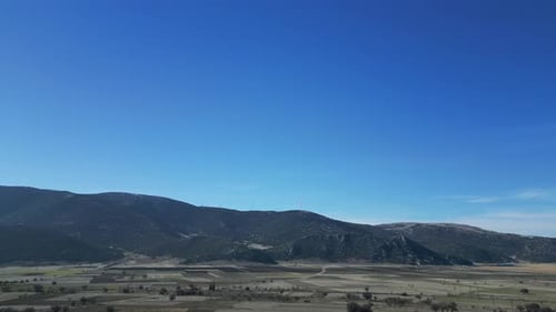 The Camera Flies From Afar to the Windmills Located on the Ridge of the Mountain