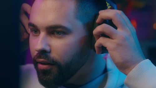 Young Adult Man Talking into a Microphone