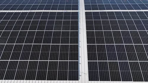 Close-up view of the surface of solar panels mounted on the roof of the building to produce clean ec