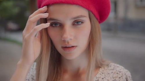 Smiling Woman Wearing Red Beret in City Close Up