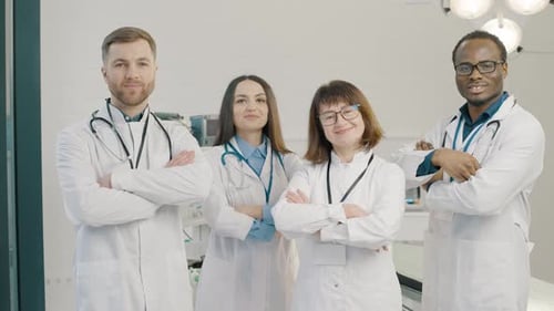 Group of doctors standing together and cross their arms in medical clinic