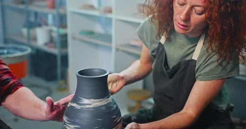 Woman Shaping Clay Vase on Pottery Wheel