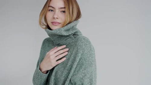 Elegant Young Woman Posing in Stylish Green Turtleneck Sweater