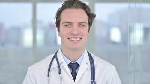 Portrait of Smiling Young Doctor Looking at the Camera