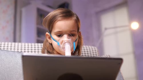 Child Using Nebulizer Mask at Home
