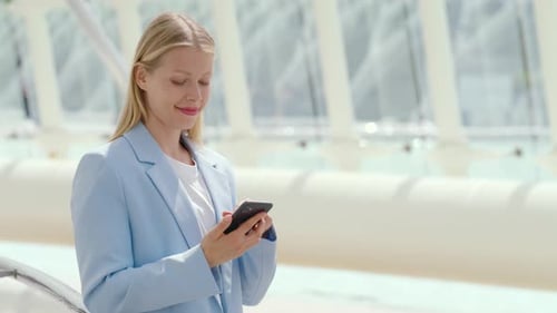 Elegant Woman on Phone Call with City's Architectural Beauty As Backdrop