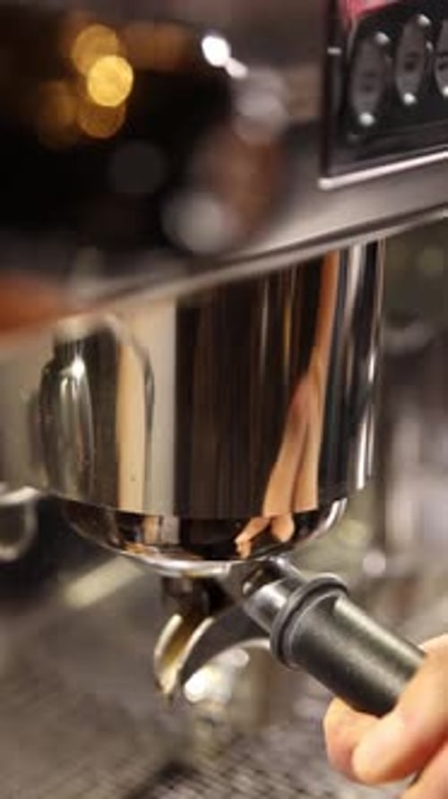 A professional bartender prepares fresh coffee in a stylish café atmosphere.