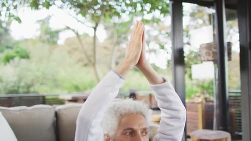 Senior Woman Meditating in Bright Modern Home