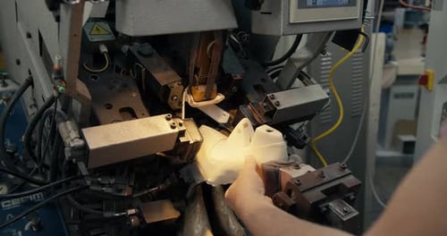 Closeup Shot of a Manual Production of Shoes on a Special Machine at a Shoe Factory Male Hands Work