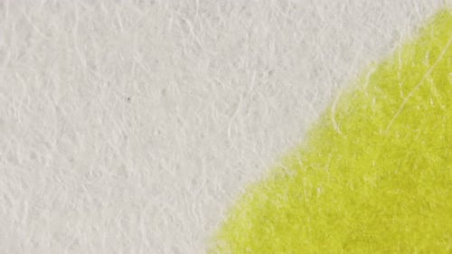 Macro Shot of Green Paint Spreading on White Surface